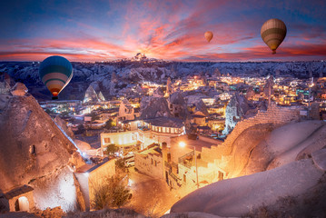 Beautiful scenes in Goreme national park. Colorful hot air balloons flying in the sky on sunset....