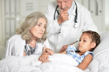 Fototapeta na wymiar Portrait of sad senior woman with granddaughter in hospital ward