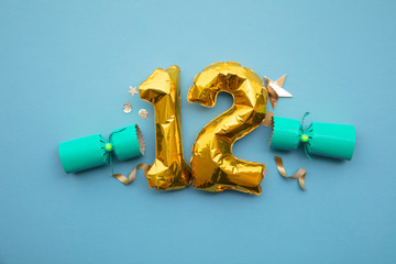 Christmas countdown. Gold number 12 with festive cristmas cracker decorations