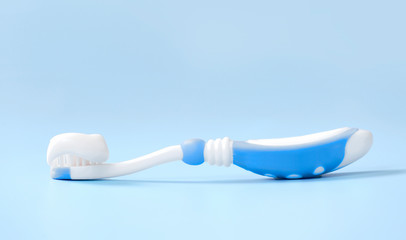 Fototapeta na wymiar Toothbrush with toothpaste on blue background,kid's dental object.
