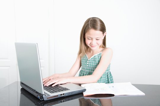 Smiling Girl Using Laptop