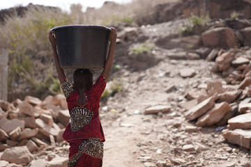 Portrait of Gorgeous African Girl Carrying Heavy Water Bucket