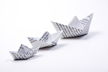 three sizes paper boats isolated on white