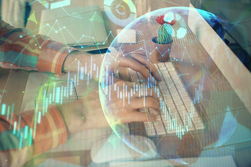 Double exposure of stock market chart with man working on computer on background. Concept of...