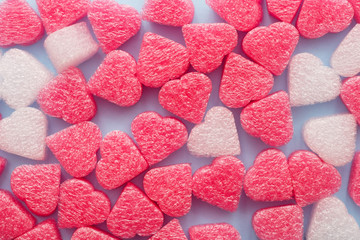 Pink and white hearts confetti close up on blue pastel background . Valentine's Day or mother's Day concept