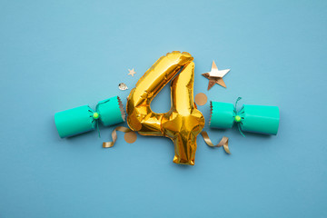 Christmas countdown. Gold number 4 with festive cristmas cracker decorations