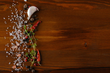 red and black pepper on wooden background