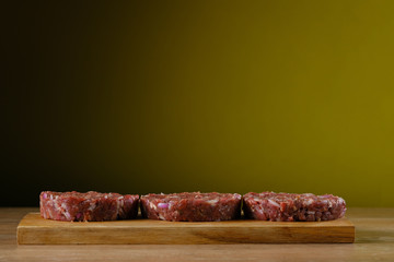 burger ingredients laid out on a wooden table
