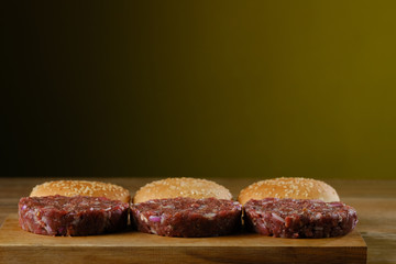 burger ingredients laid out on a wooden table