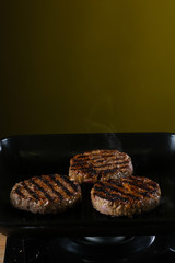 Burger patties are fried in a pan 