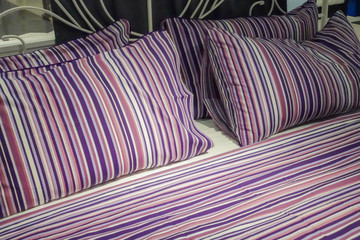 sleeping room with purple bed sheets