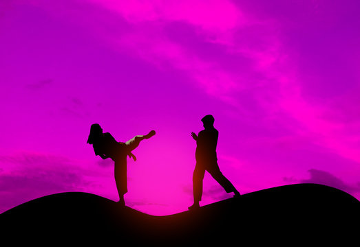 Silhouette fighter taekwondo kids,Concept fight taekwondo in the atmosphere on mountain sunset.