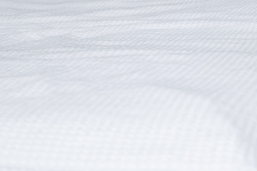 textured white bedding on the bed, prepared for bed, pillows