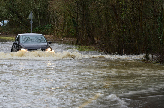 Horley,Surrey/United Kingdom- December 29 2019: The River Mole Has Flooded Its Banks, Cars Are Trying To Drive Through The Flood Waters