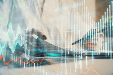 Financial chart drawn over hands taking notes background. Concept of research. Multi exposure