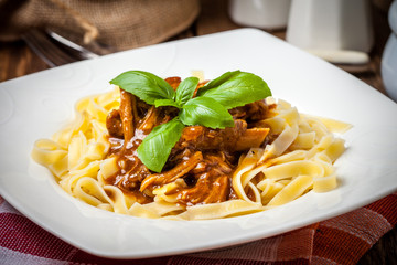 Tagliatelle with dark sauce.