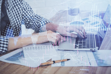 Multi exposure of stock market chart with man working on computer on background. Concept of financial analysis.