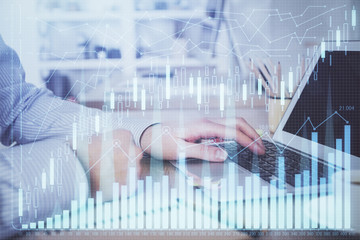 Multi exposure of stock market chart with man working on computer on background. Concept of financial analysis.