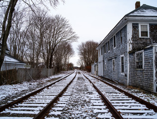 Fototapeta premium Railroad Tracks and A Broken Down Building In Winter