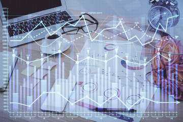 Financial graph colorful drawing and table with computer on background. Double exposure. Concept of international markets.