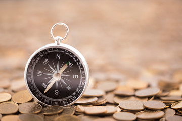 Financial concept with coins and compass