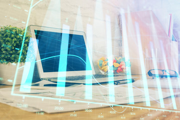 Obraz na płótnie Canvas Stock market chart hologram drawn on personal computer background. Double exposure. Concept of investment.