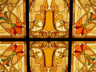 Detail of a back lit stained glass window with vibrant colors