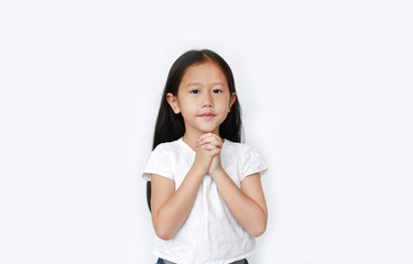 Beautiful little asian child girl praying isolated over white background. Spirituality and religion concept.