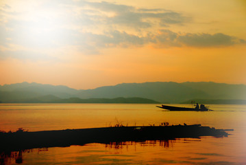 Fototapeta na wymiar silhouette boat on lake