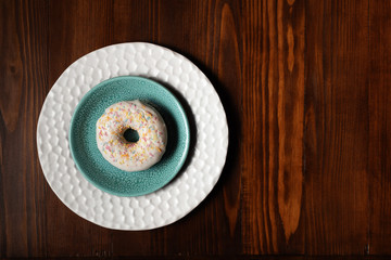 Donut on plate, sweet food background, space for copy	
