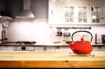 Kettle on wooden table and free space for your decoration.