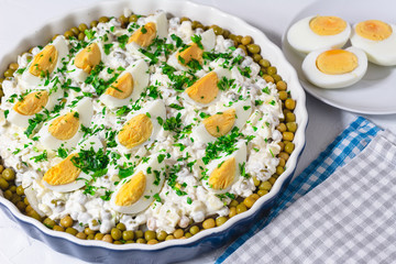 Salted herring in a cream sauce with apple, onion, peas and egg