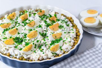 Salted herring in a cream sauce with apple, onion, peas and egg