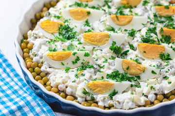 Salted herring in a cream sauce with apple, onion, peas and egg
