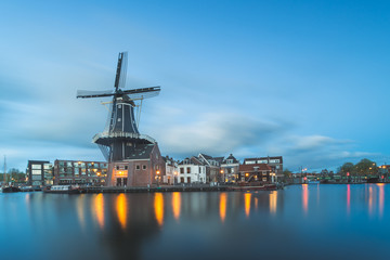 Fototapeta na wymiar Windmill and Spaarne River, Haarlem, Netherlands