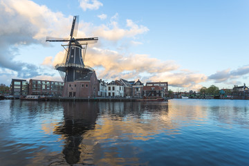 Fototapeta na wymiar Windmill and Spaarne River, Haarlem, Netherlands