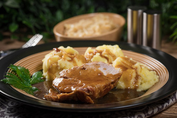 Braised pork neck in own sauce. Shallow depth of field.
