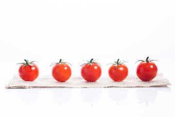 Row of  fresh Tomatoes on white background.