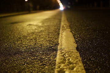 Separation line on the asphalt. Night road. Macro view. - 310870424