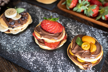Obraz na płótnie Canvas Pancakes with banana, strawberry and chocolate for shrove tuesday