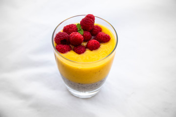 Chia pudding and Mango smoothie with raspberry topping