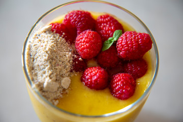 Chia pudding and Mango smoothie with raspberry and granola topping