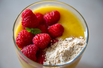 Chia pudding and Mango smoothie with raspberry and granola topping