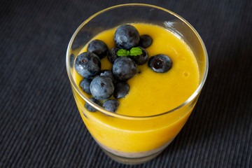 Chia pudding and Mango smoothie with blueberry amd granola topping
