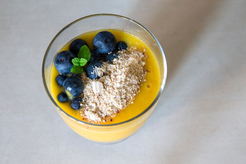 Chia pudding and Mango smoothie with blueberry amd granola topping