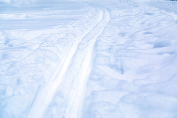 deep ski track on fluffy blue snow