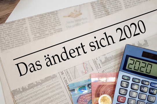 Newspaper with money and calculator and german headline Changes coming in 2020 - das ändert sich 2020