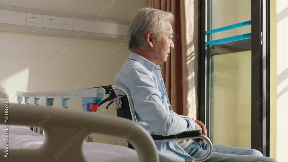 Poster asian old man sitting in wheel chair alone in his room in nursing home