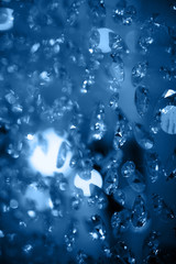 Crystal chandelier close-up. Glamour background blue toned