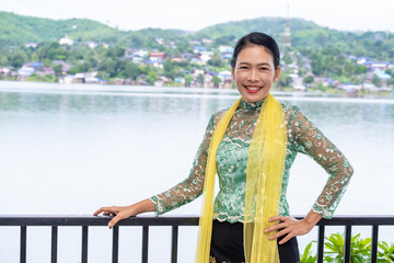 Thai women get dress traditional costume of Mon tribal at Mon village, Sangkhlaburi, Kanchanaburi, Thailand.